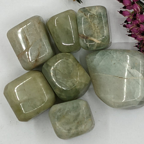 Aquamarine Tumbled Stone showcasing smooth, polished crystals in blue hues, known for their ability to promote calm, clarity, and emotional healing.
