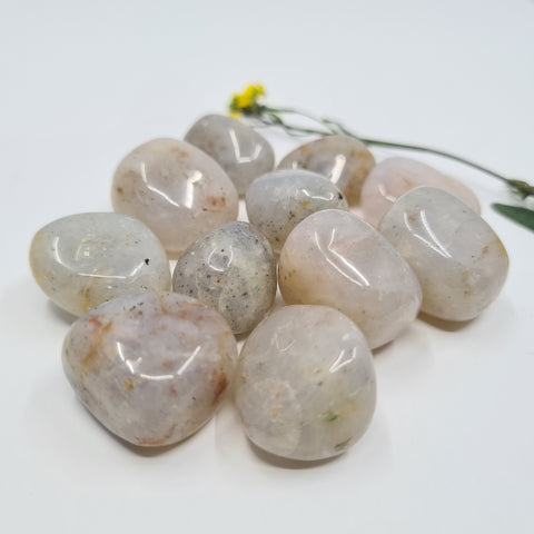 Chalcedony Tumbled Stone showcasing smooth, polished crystals in soft blue hues, known for their ability to promote harmony, clear communication, and emotional balance.
