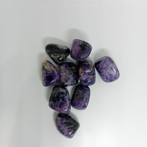 Chrysoberyl Tumbled Stone showcasing smooth, polished crystals in yellow and green hues, known for their ability to enhance clarity, confidence, and emotional strength.