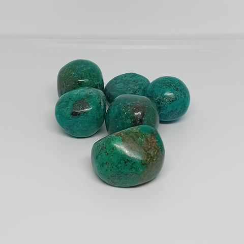 Chrysocolla Tumbled Stones showcasing smooth, polished crystals in turquoise and green hues, known for their ability to enhance communication, emotional healing, and personal growth.