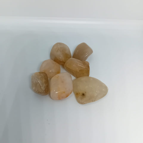 Golden Healer Tumbled Stone showcasing smooth, polished crystals in golden hues, known for their ability to restore vitality, promote energy flow, and enhance spiritual growth.