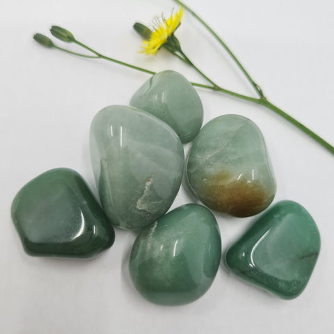 Green Aventurine Tumbled Stone showcasing smooth, polished crystals in green hues, known for their ability to attract abundance, promote healing, and encourage personal growth.