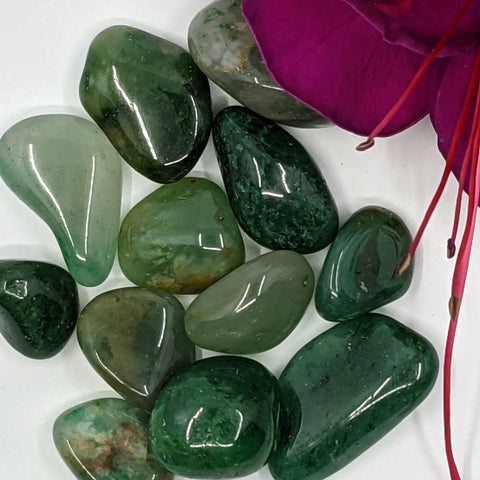 Green Chalcedony Tumbled Stone showcasing smooth, polished crystals in soft green hues, known for their ability to promote emotional healing, balance, and inner peace.