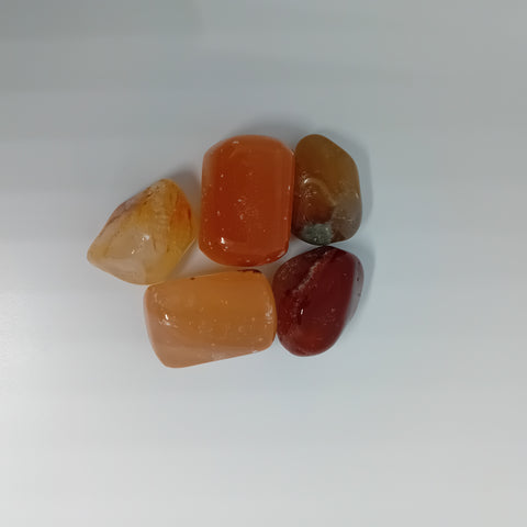 Honey Calcite Tumbled Stones showcasing smooth, polished crystals in golden yellow hues, known for their ability to boost confidence, clarity, and vitality.