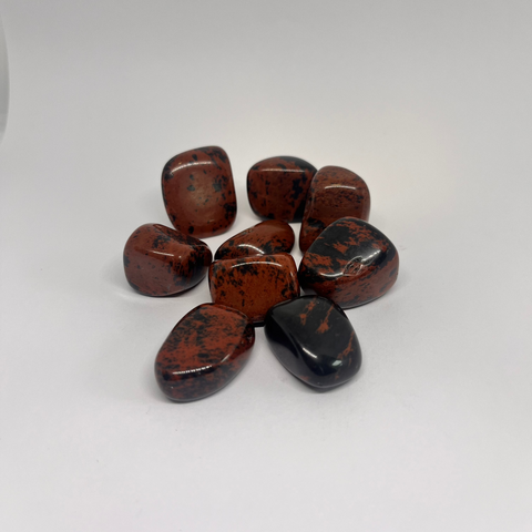 Mahogany Obsidian Tumbled Stones in rich dark brown and black hues with smooth, glossy surfaces, known for their grounding and protective properties, helping to release negative energies and enhance personal strength.
