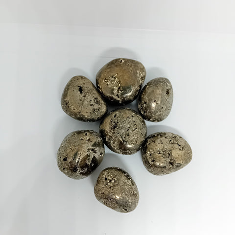 Pyrite Tumbled Stone showcasing smooth, polished crystals in golden hues, known for their ability to attract abundance, boost confidence, and enhance manifestation.