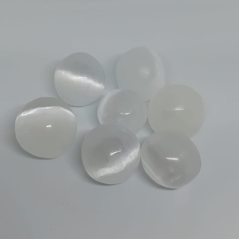 Selenite Tumbled Stone showcasing smooth, polished crystals in translucent white hues, known for their ability to purify energy, promote clarity, and enhance spiritual growth.