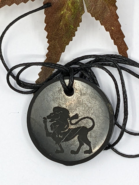 Shungite Leo zodiac sign pendant necklace on a white background, for vitality and confidence.