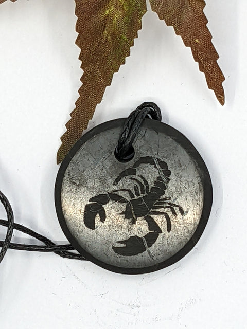 Shungite Scorpio zodiac sign pendant necklace on a white background, for transformation and protection.