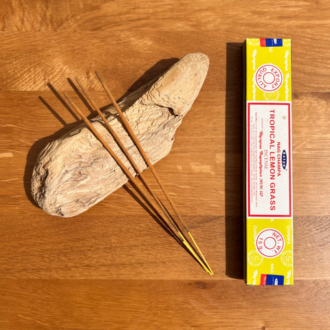Satya Tropical Lemon Grass Incense Sticks 15g box on a wooden background, offering a bright, citrusy fragrance.