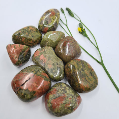 Unakite Tumbled Stones showcasing smooth, polished crystals in vibrant green and pink hues, known for their ability to promote emotional healing, balance, and personal growth.