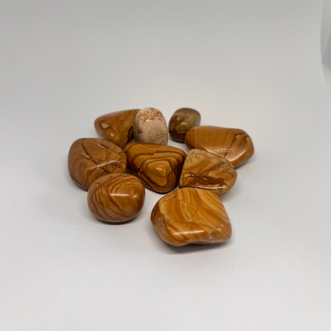 Walnut Jasper Tumbled Stones with warm, earthy tones of brown and cream, known for promoting grounding, stability, and balance in one's life.