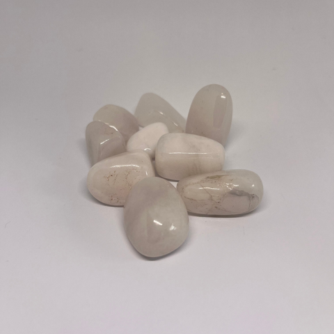 White Onyx Tumbled Stones showcasing smooth, polished, and natural crystal shapes with varying shades of off-white and subtle veins, perfect for healing and meditation.