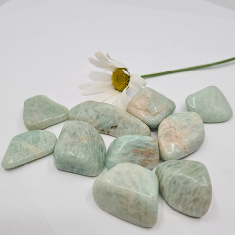 Amazonite Tumbled Stone showcasing smooth, polished crystals in green-blue hues, known for their ability to promote emotional balance, enhance communication, and soothe the mind.