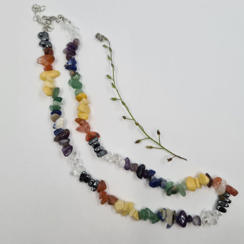 Chakra Balancing Crystal Chip Necklace with colorful gemstone chips on a white background.