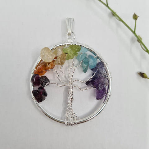 Tree of Life Chakra Chip Pendant with colorful gemstone chips in a Tree of Life design on a white background.