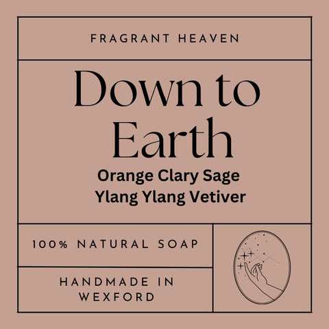 Front label of Down To Earth Handmade Soap bar, 100% natural with vetiver, orange, and clary sage, enriched with chamomile for a calming and grounding experience.