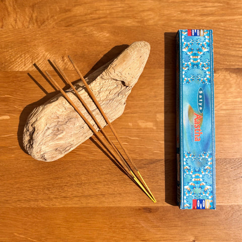 Satya Aastha Incense Sticks 15g box on a wooden background, designed for spiritual awareness and uplifting energy. 