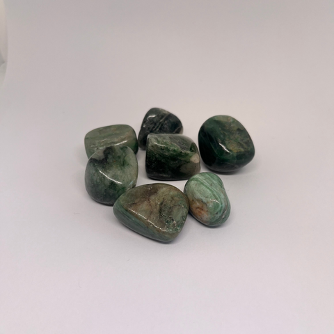 African Jade Tumbled Stones with smooth, polished crystals in shades of green and brown, known for their calming energy, emotional healing properties, and ability to promote abundance and prosperity.