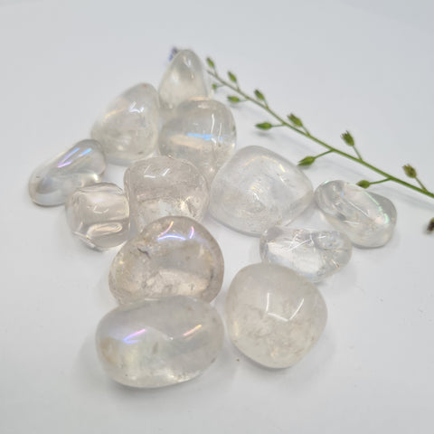 Angel Aura Quartz Tumbled Stones displaying smooth, polished crystals with a clear, iridescent finish, known for their ability to enhance spiritual connection, bring tranquility, and amplify energy.