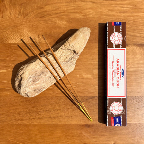 Satya Arabian Oudh Incense Sticks 15g box on a wooden background, featuring a deep and luxurious fragrance.
