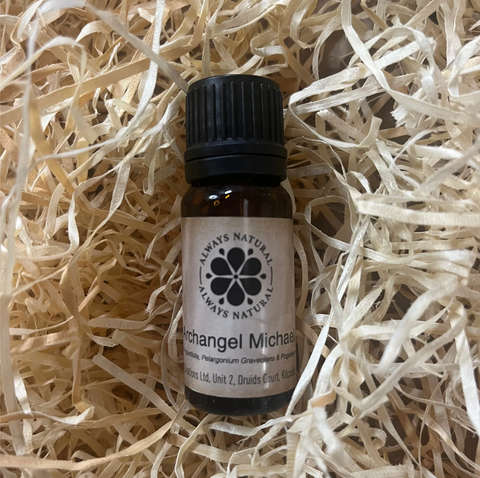 Bottle of 'Always Natural' Archangel Michael oil on a bed of straw.