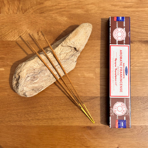 Satya Aromatic Frankincense Nag Champa Incense Sticks 15g box on a wooden background, perfect for meditation and prayer.