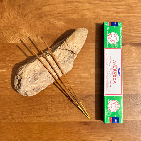 Satya Ayurveda Nag Champa Incense Sticks 15g box on a wooden background, crafted to promote balance and harmony.