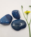 Blue Agate Tumbled Stones featuring smooth, polished crystals in deep blue tones with natural banding, known for their calming and healing properties, ideal for emotional balance and mental clarity.