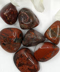 Brecciated Jasper Tumbled Stones featuring smooth, polished crystals with vibrant red, orange, and brown hues, known for their grounding energy, strength-enhancing properties, and ability to support emotional healing.