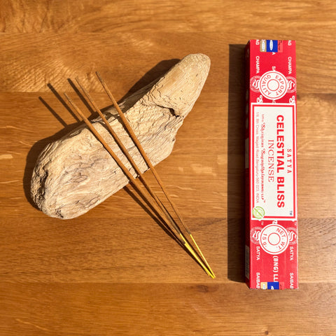 Satya Celestial Bliss Incense Sticks 15g box on a wooden background, designed to uplift and create a peaceful atmosphere.