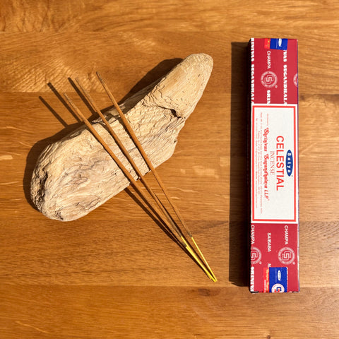 Satya Celestial Incense Sticks 15g box on a wooden background, offering an uplifting aroma for spiritual connection.