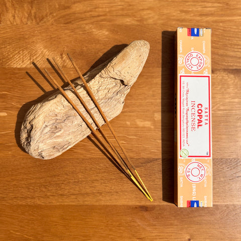 Satya Copal Incense Sticks 15g box on a wooden background, featuring a purifying and uplifting scent for spiritual work.