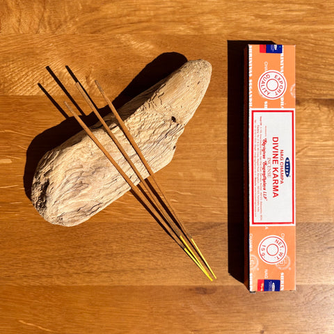 Satya Divine Karma Incense Sticks 15g box on a wooden background, designed to balance energy and promote positivity.