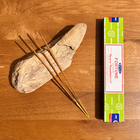 Satya Fortune Incense Sticks 15g box on a wooden background, crafted to attract prosperity and positive energy.