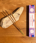 Satya French Lavender Nag Champa Incense Sticks 15g box on a wooden background, with a calming and relaxing fragrance.
