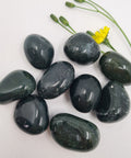 Green Jasper Tumbled Stones displaying smooth, polished crystals in deep green hues with natural speckling, known for their grounding energy, emotional healing properties, and ability to enhance stability and balance.