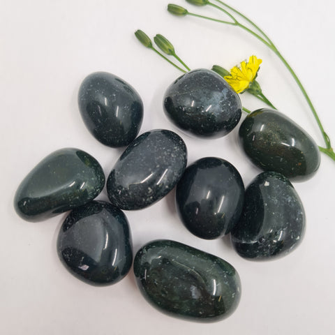 Green Jasper Tumbled Stones displaying smooth, polished crystals in deep green hues with natural speckling, known for their grounding energy, emotional healing properties, and ability to enhance stability and balance.