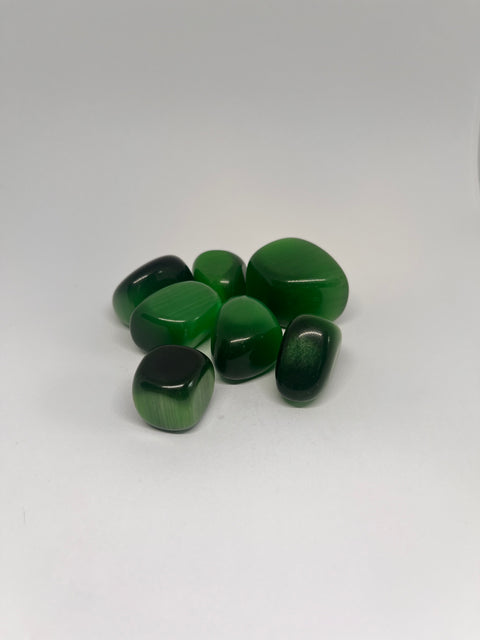 Green Cats Eye Tumbled Stones, featuring vibrant shades of green with a characteristic eye-like sheen across the surface.