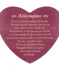 Heart-shaped card with an affirmation message promoting gratitude, positive thinking, and the power of creation, written in gold text.