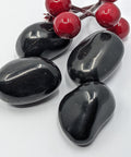 Large shungite tumbled stone on a white background, for grounding and energy clearing.