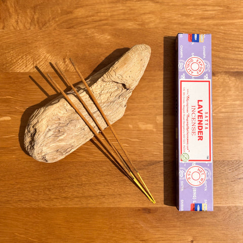 Satya Lavender Incense Sticks 15g box on a wooden background, featuring a soothing and stress-relieving aroma.
