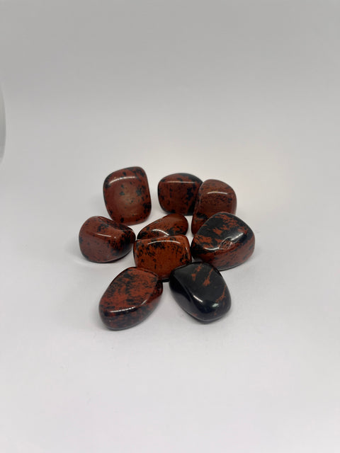 Mahogany Obsidian Tumbled Stones in rich dark brown and black hues with smooth, glossy surfaces, known for their grounding and protective properties, helping to release negative energies and enhance personal strength.