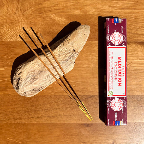 Satya Meditation Incense Sticks 15g box on a wooden background, crafted to enhance mindfulness and relaxation.