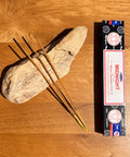 Satya Midnight Incense Sticks 15g box on a wooden background, with a deep and calming fragrance for relaxation.