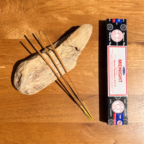 Satya Midnight Incense Sticks 15g box on a wooden background, with a deep and calming fragrance for relaxation.