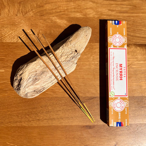 Satya Myrrh Incense Sticks 15g box on a wooden background, offering an ancient and sacred aroma for purification.