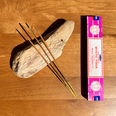 atya Mystic Yoga Nag Champa Incense Sticks 15g box on a wooden background, crafted to enhance yoga and meditation.