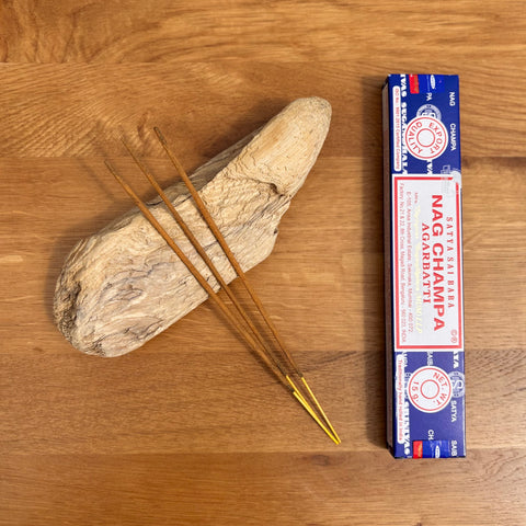 Satya Nag Champa Box Of Incense Sticks on wooden background, offering a soothing and spiritually uplifting aroma