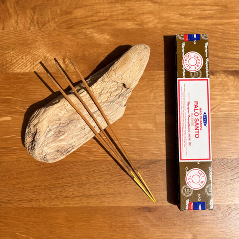 Satya Palo Santo Nag Champa Incense Sticks 15g box on a wooden background, combining purification with a soothing aroma.
